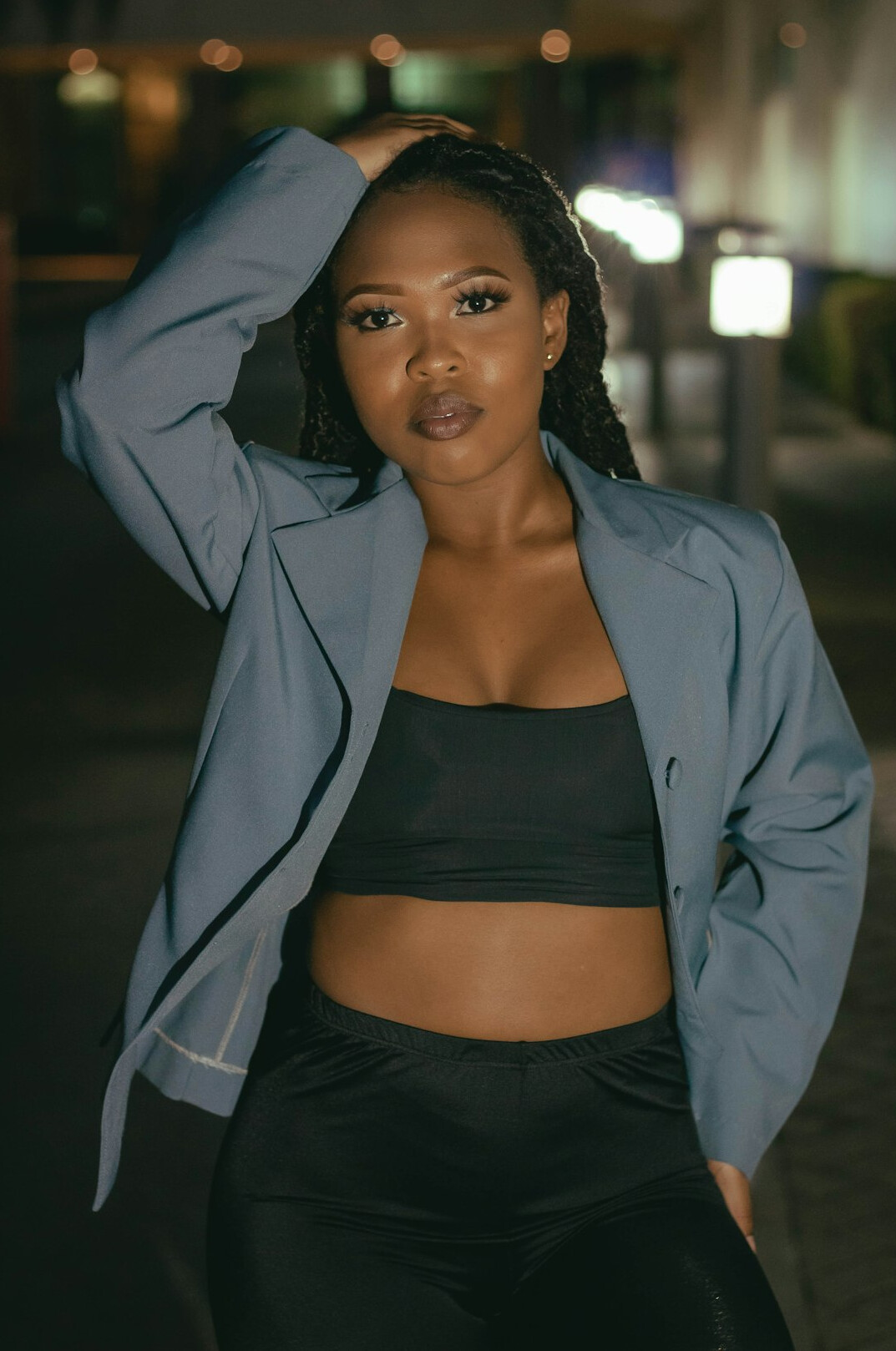 Portrait of a Black woman in a blazer smiling at the camera